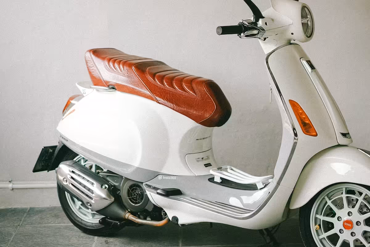 Custom Vespa seat in vibrant urban setting with street art background